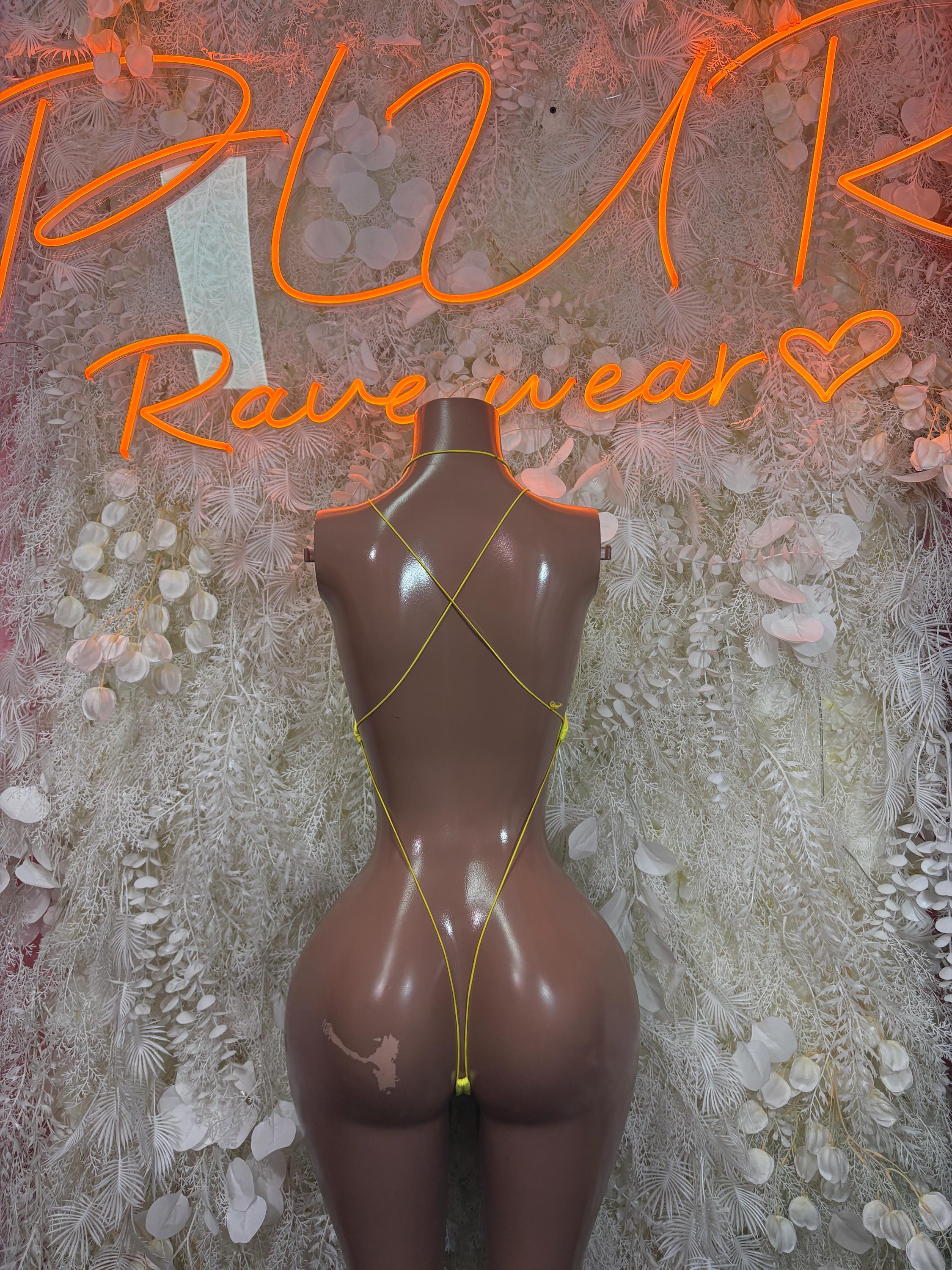 Back view yellow bodysuit with black trim and crisscross back straps
