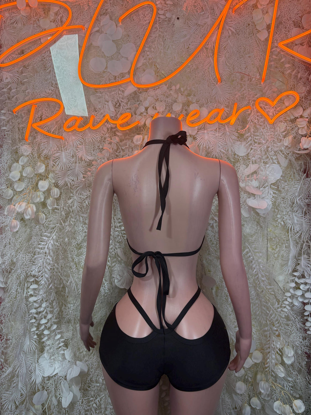 Black festival bodysuit set with tie-back straps and matching high-cut bottoms