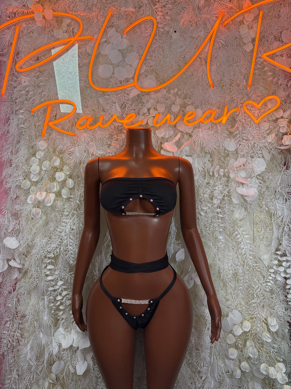 Black two-piece bodysuit set with strapless bandeau top and high-leg thong bottoms, chain details