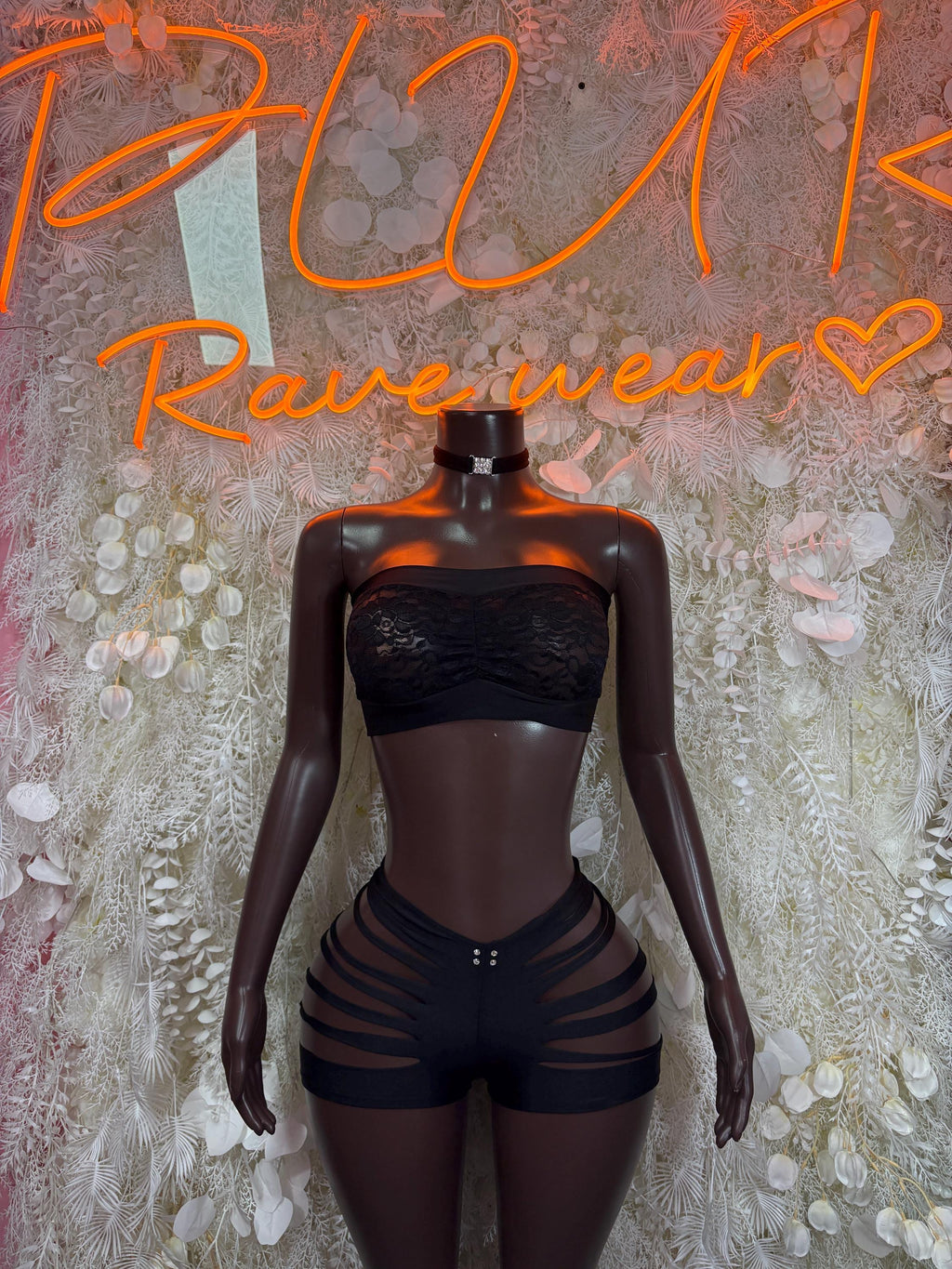 Black two-piece bodysuit with bandeau top and strappy striped shorts, front view