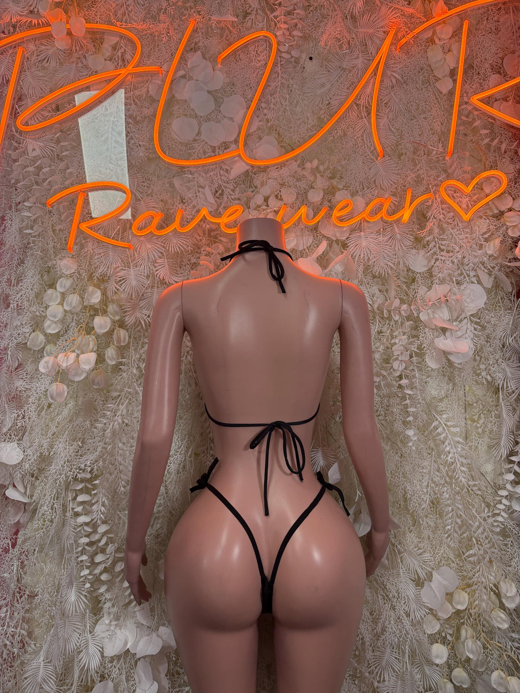 Black bikini two-piece back view with crisscross tie straps and minimal coverage