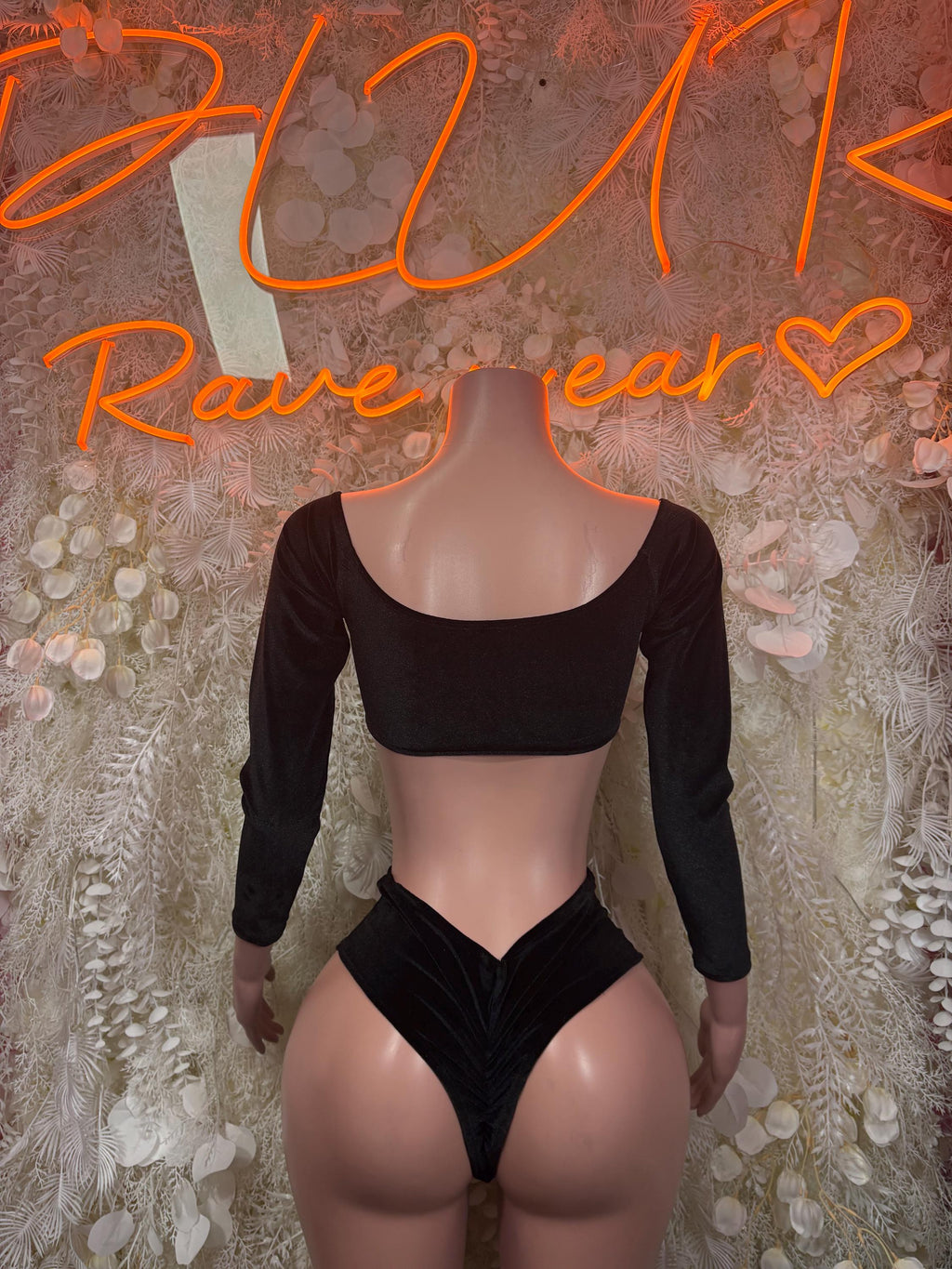 Black long-sleeve crop top with scoop back and high-cut bottoms