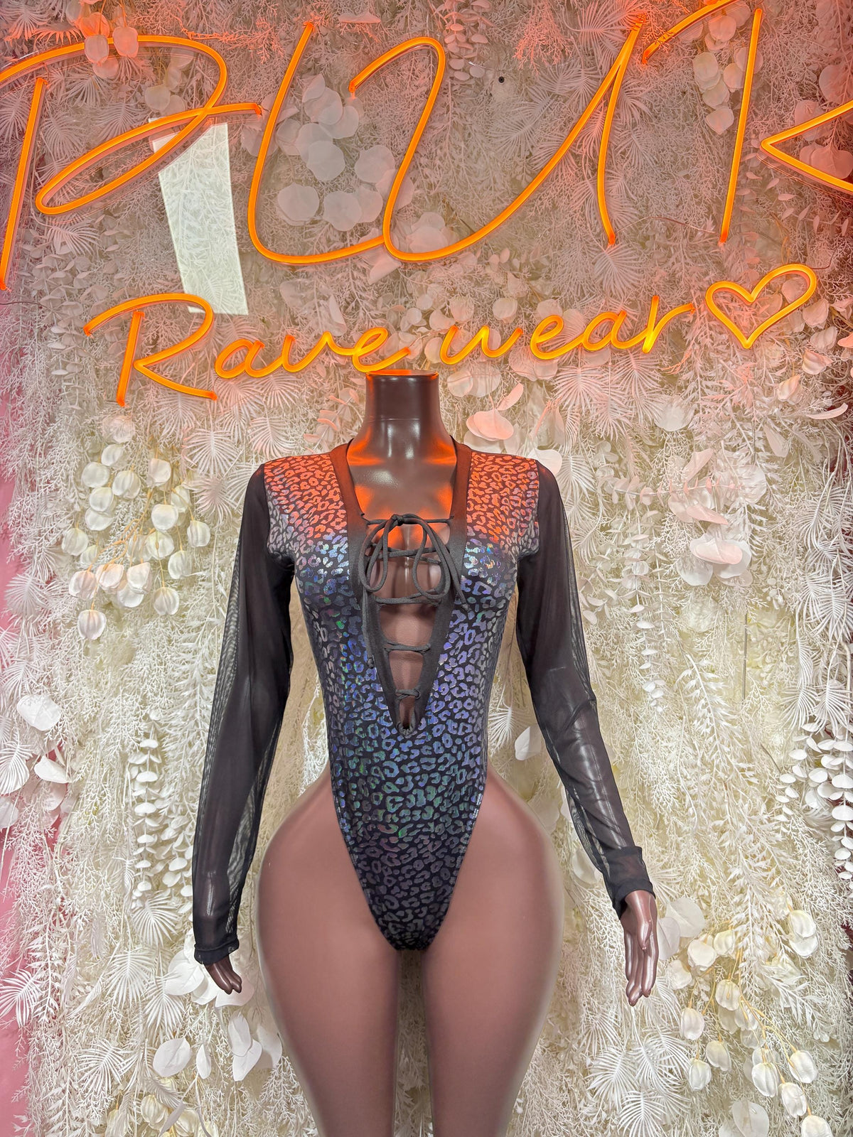Black one-piece bodysuit with long sheer sleeves, metallic cheetah print and lace-up bust