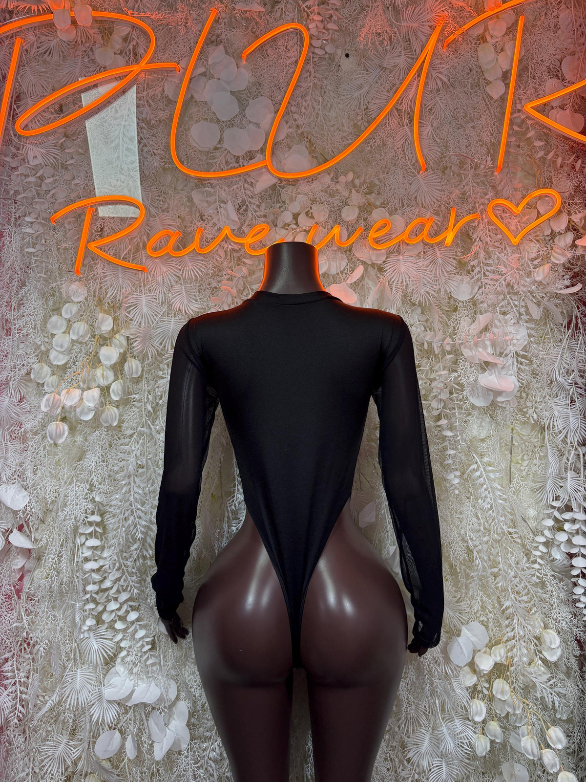 Black one-piece bodysuit back view with full coverage and long sheer sleeves