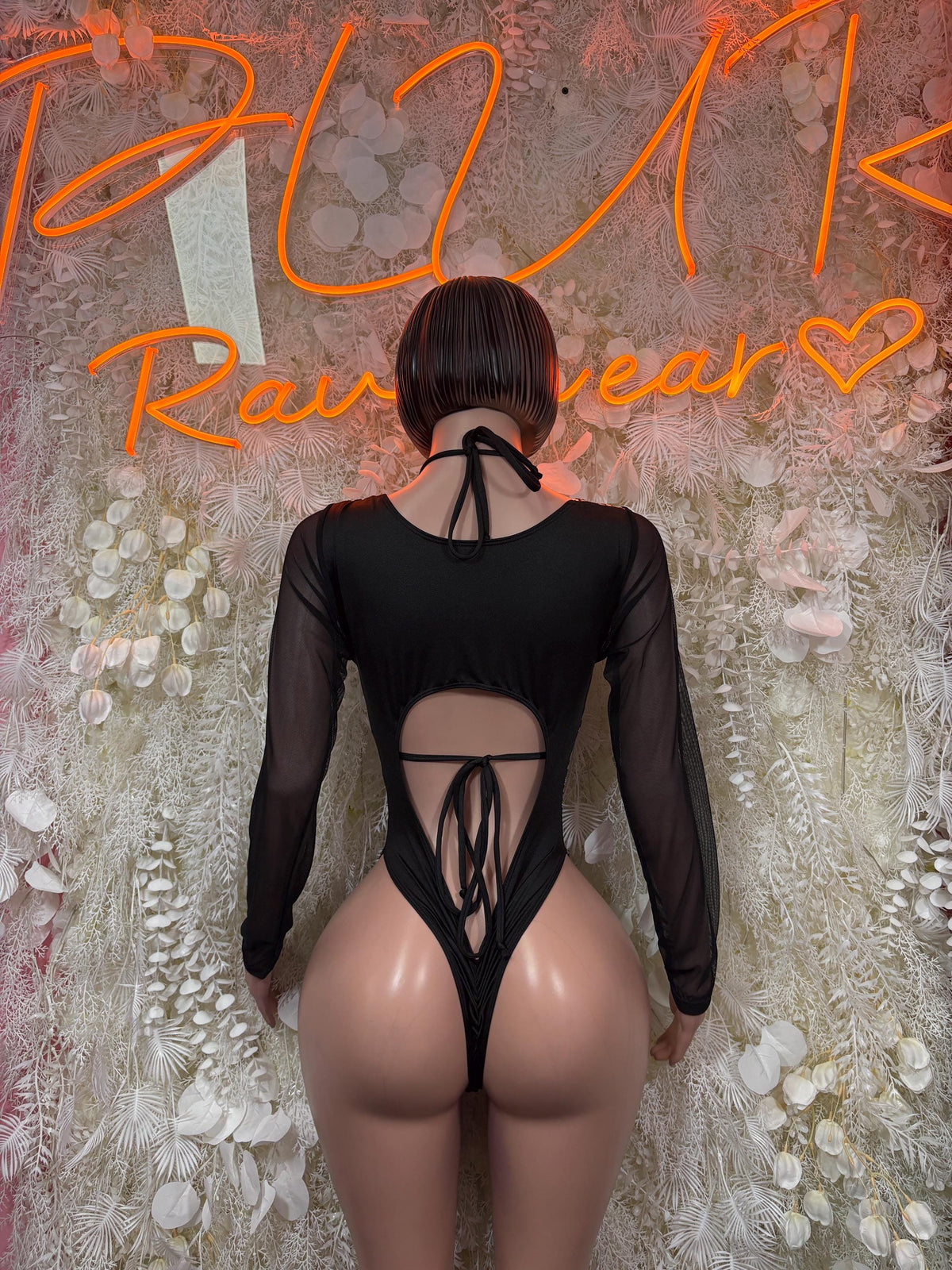 Back view leopard-print bodysuit with open lace-up center and sheer long sleeves, dark