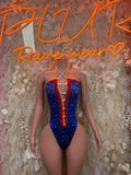 Patriotic one-piece bodysuit with blue star print, red-and-white panel trim, deep V