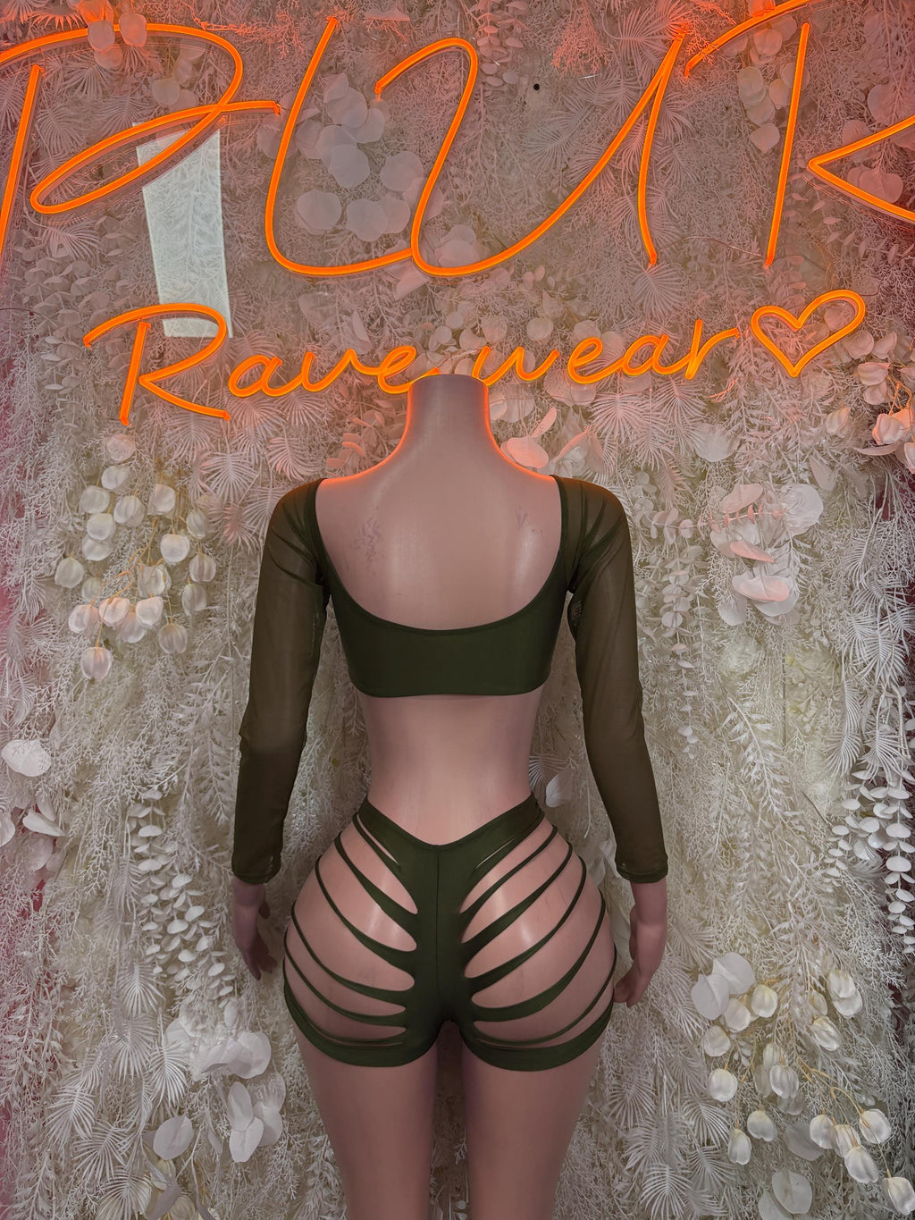 Green two-piece rave set, back view: long sleeves with scoop back and striped shorts