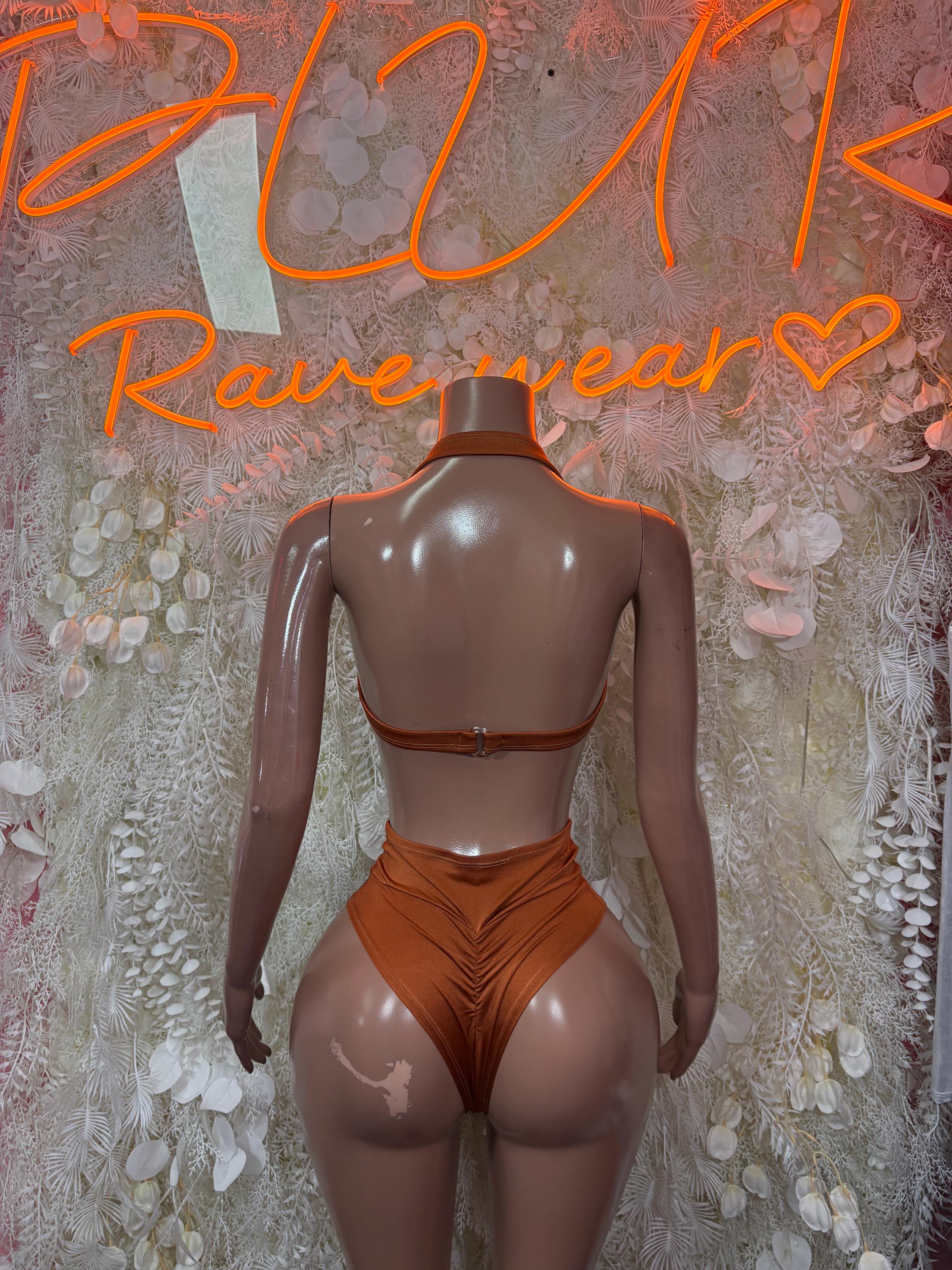 Orange two-piece dance outfit, back view: rhinestone halter bra and high-rise bottoms