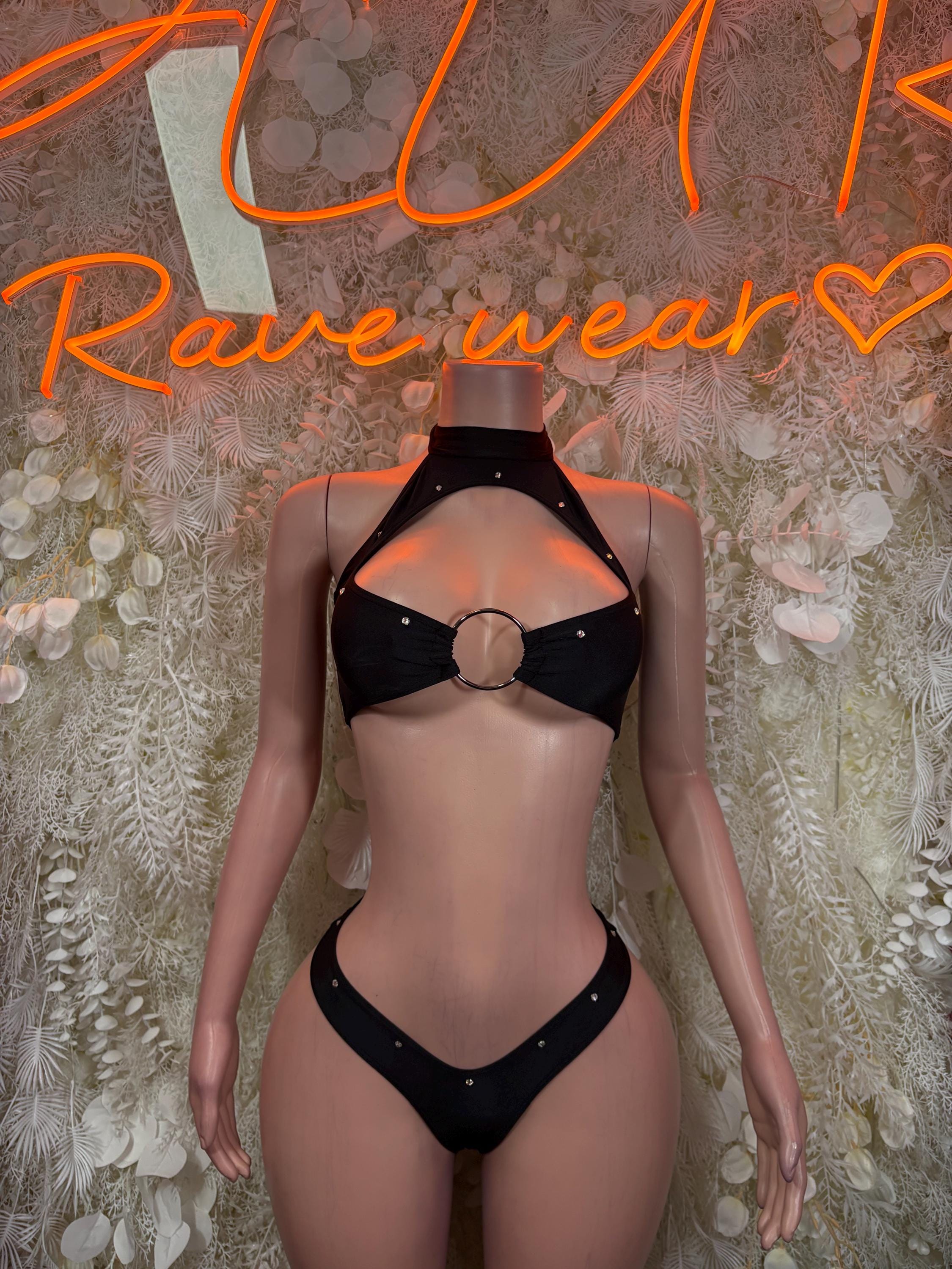 Black rave two-piece set: ring-detail halter top and matching high-cut bottoms