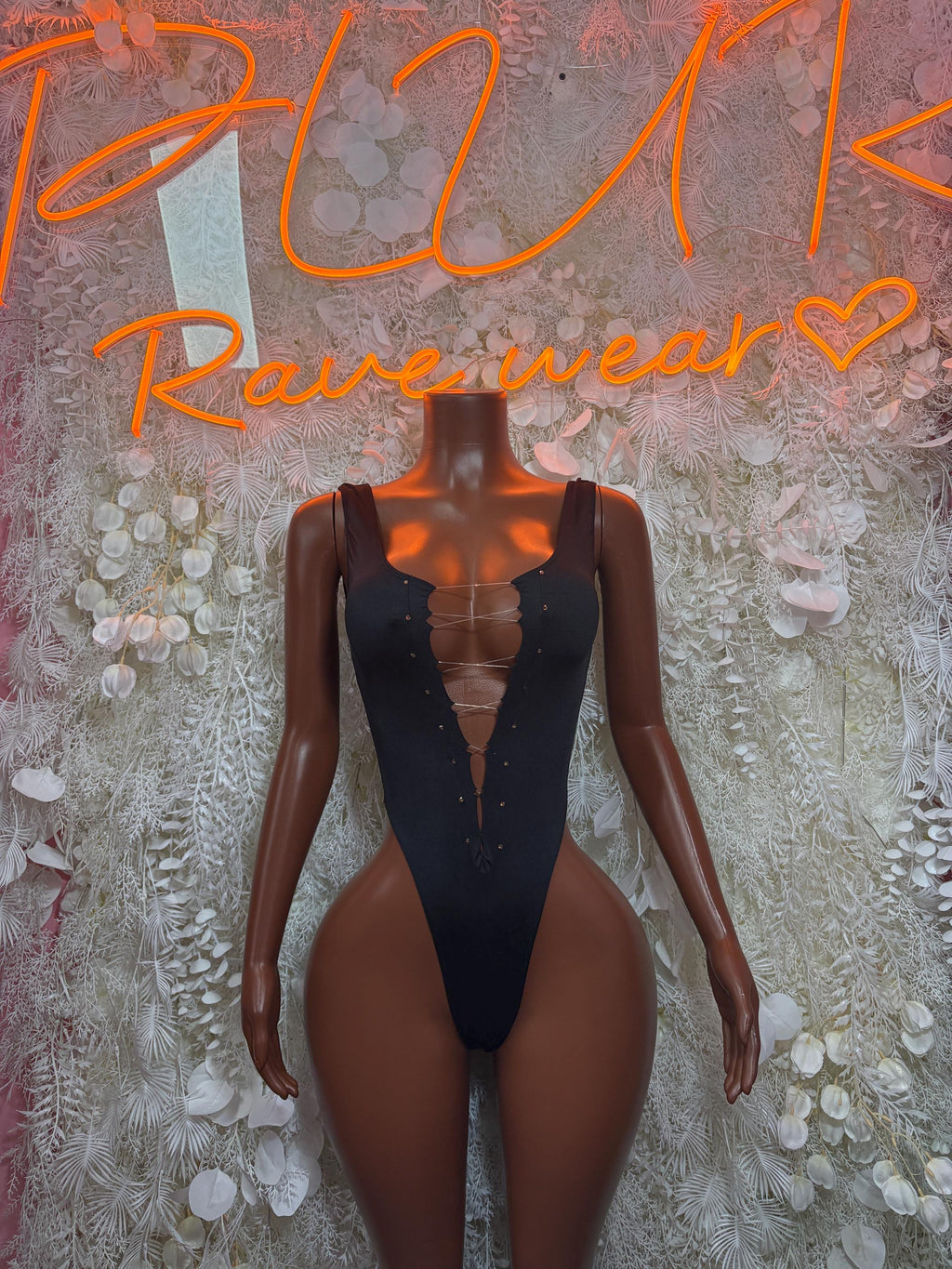 Black lace-up bodysuit with deep V neckline and high-cut legs