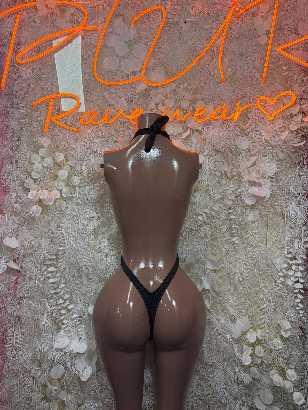 Black halter bodysuit with open back cutout and thin shoulder straps
