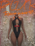 Black halter bodysuit with deep chest cutout and red bow center detail