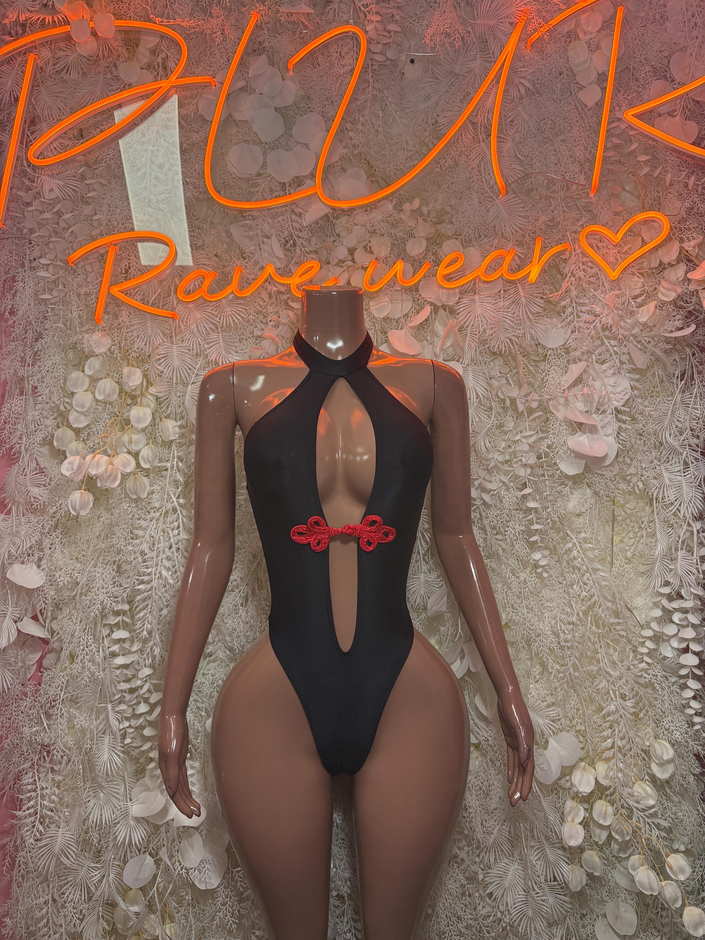 Black halter bodysuit with deep chest cutout and red bow center detail