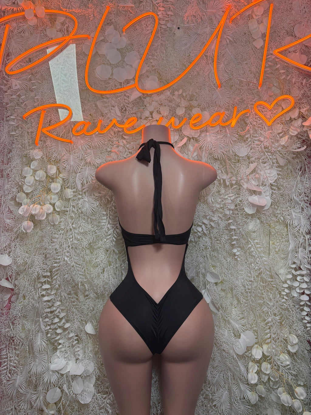 Black halter bodysuit with open back and V-shaped cut