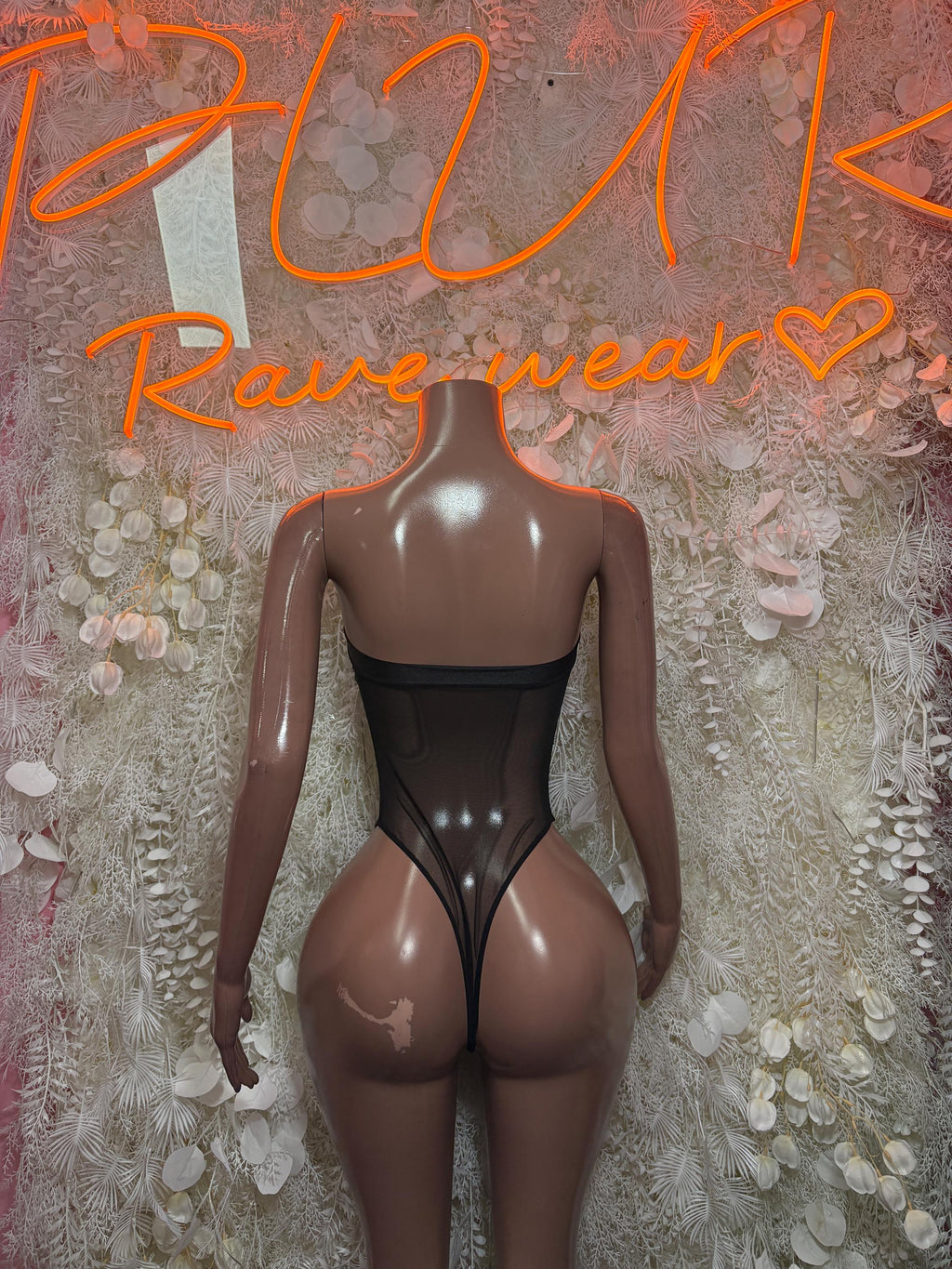 Black bodysuit one-piece with open back and sheer mesh panels