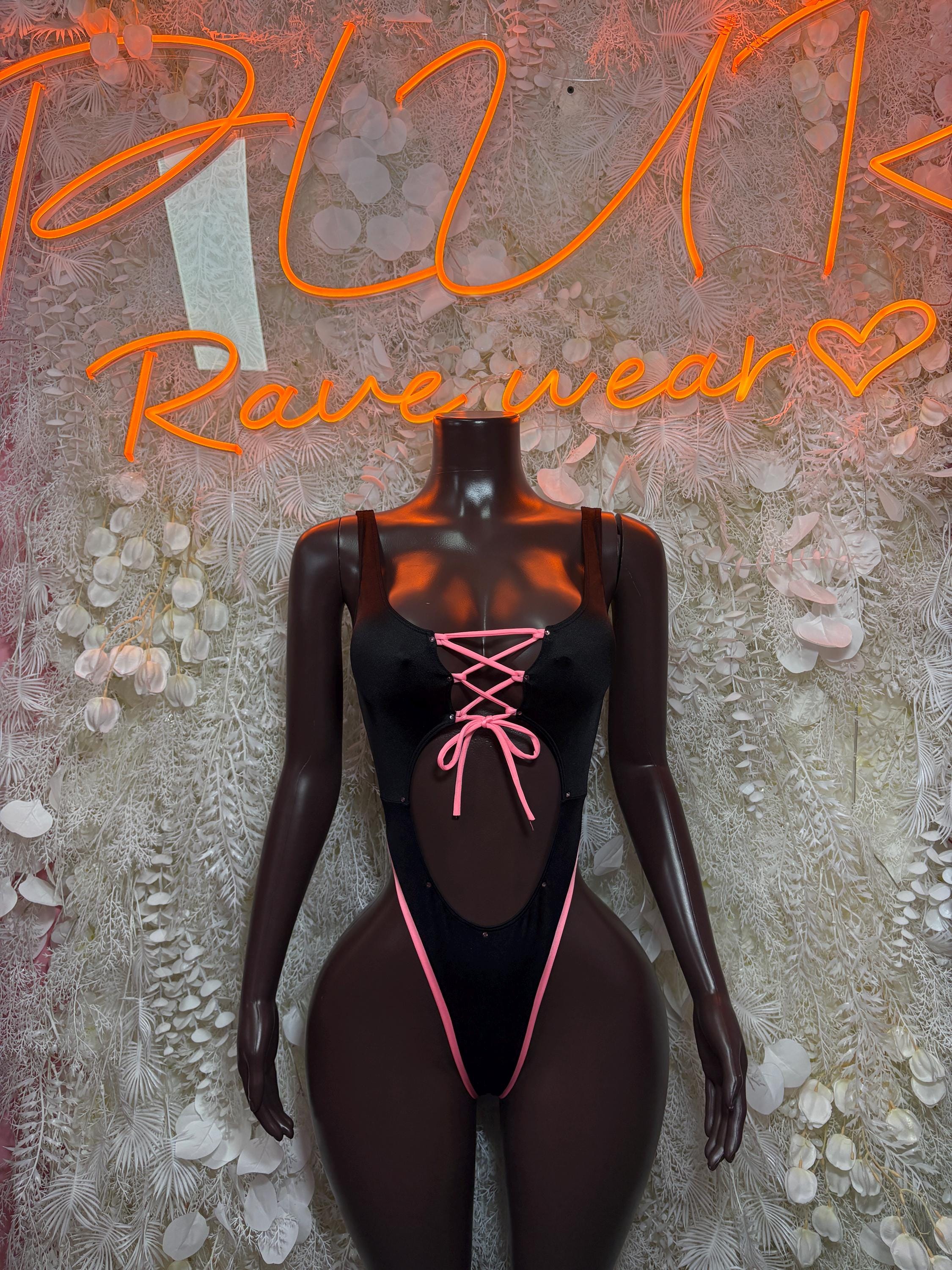 Black bodysuit with neon pink lace-up neckline and open chest cutout