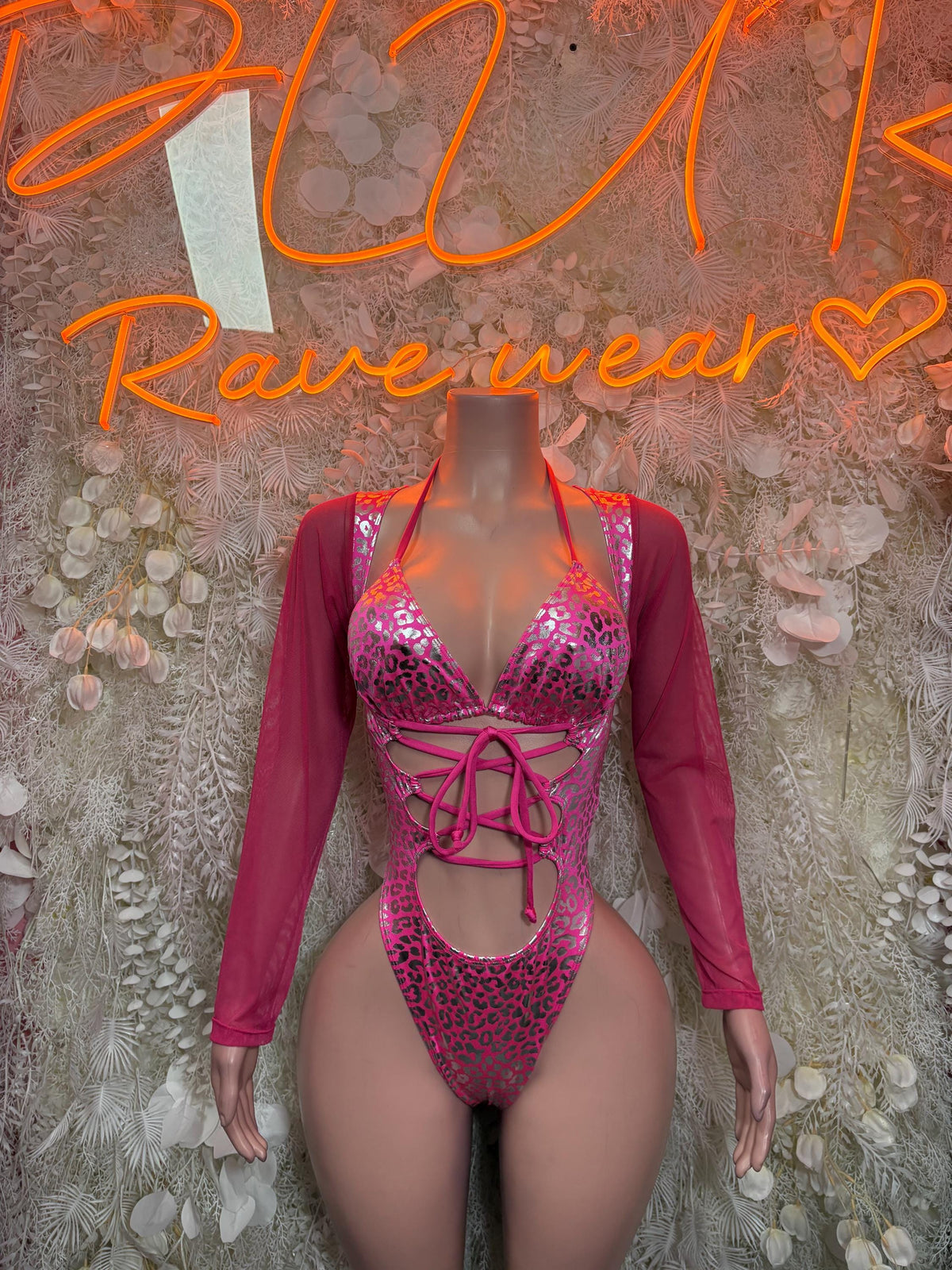 Hot pink cheetah-print metallic bodysuit with long sleeves and lace-up front