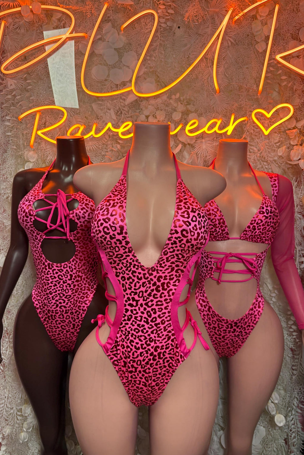 Hot pink cheetah-pattern metallic bodysuit on mannequins, lace-up front and halter ties