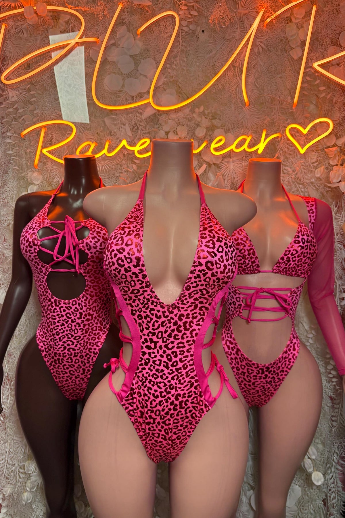 Hot pink cheetah-pattern metallic bodysuit on mannequins, lace-up front and halter ties