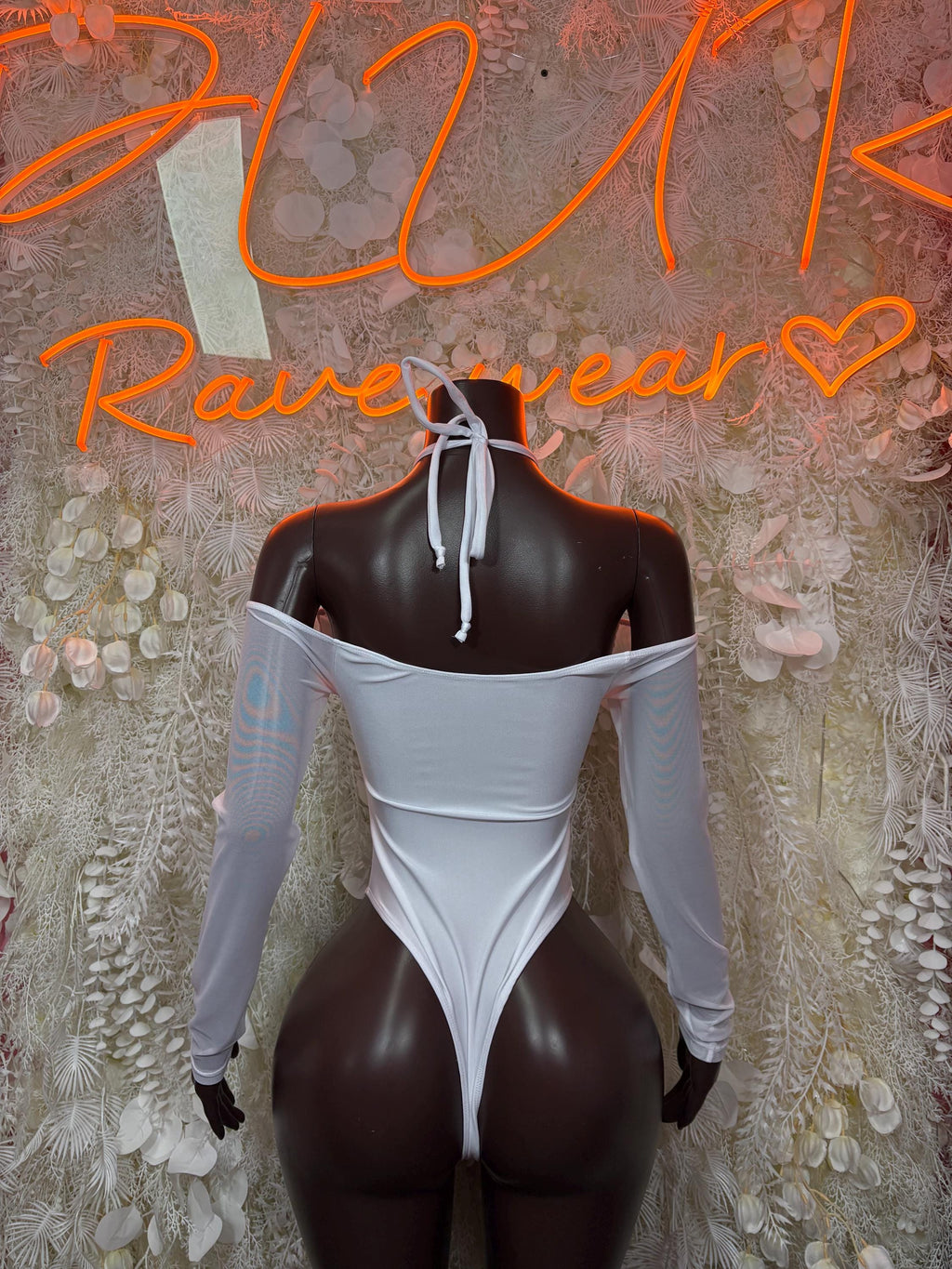 White lace-up bodysuit with off-shoulder long sleeves and neck tie, mannequin back
