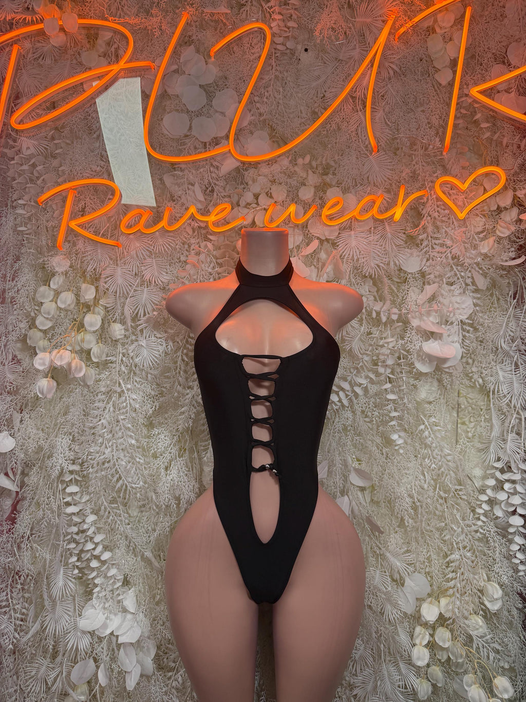 Black lace-up cutout bodysuit with halter neckline and vertical chest cutout
