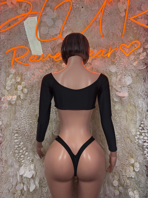 Black two-piece rave outfit: long-sleeve crop top and V-string thong bottoms, rear view