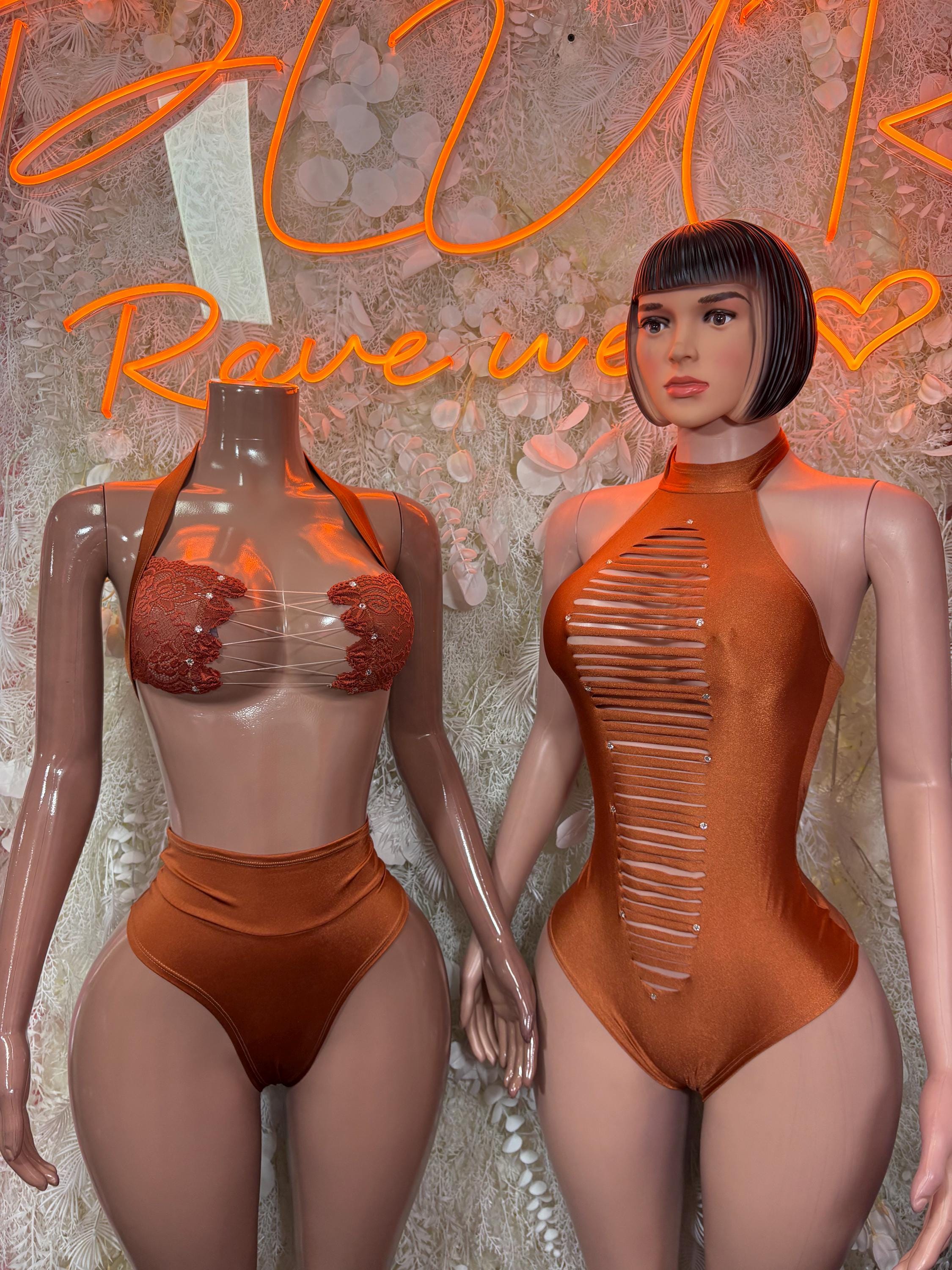 Orange halter one-piece bodysuit with ruched neckline, ribbed front, and high-cut back