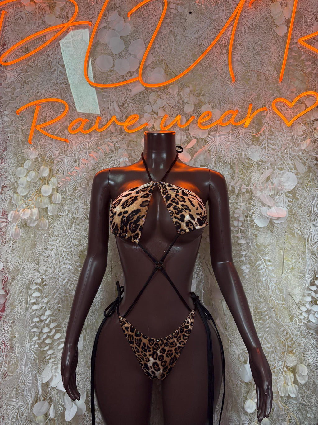 Leopard print one-piece bodysuit with deep V neck and crisscross straps, sheer mesh