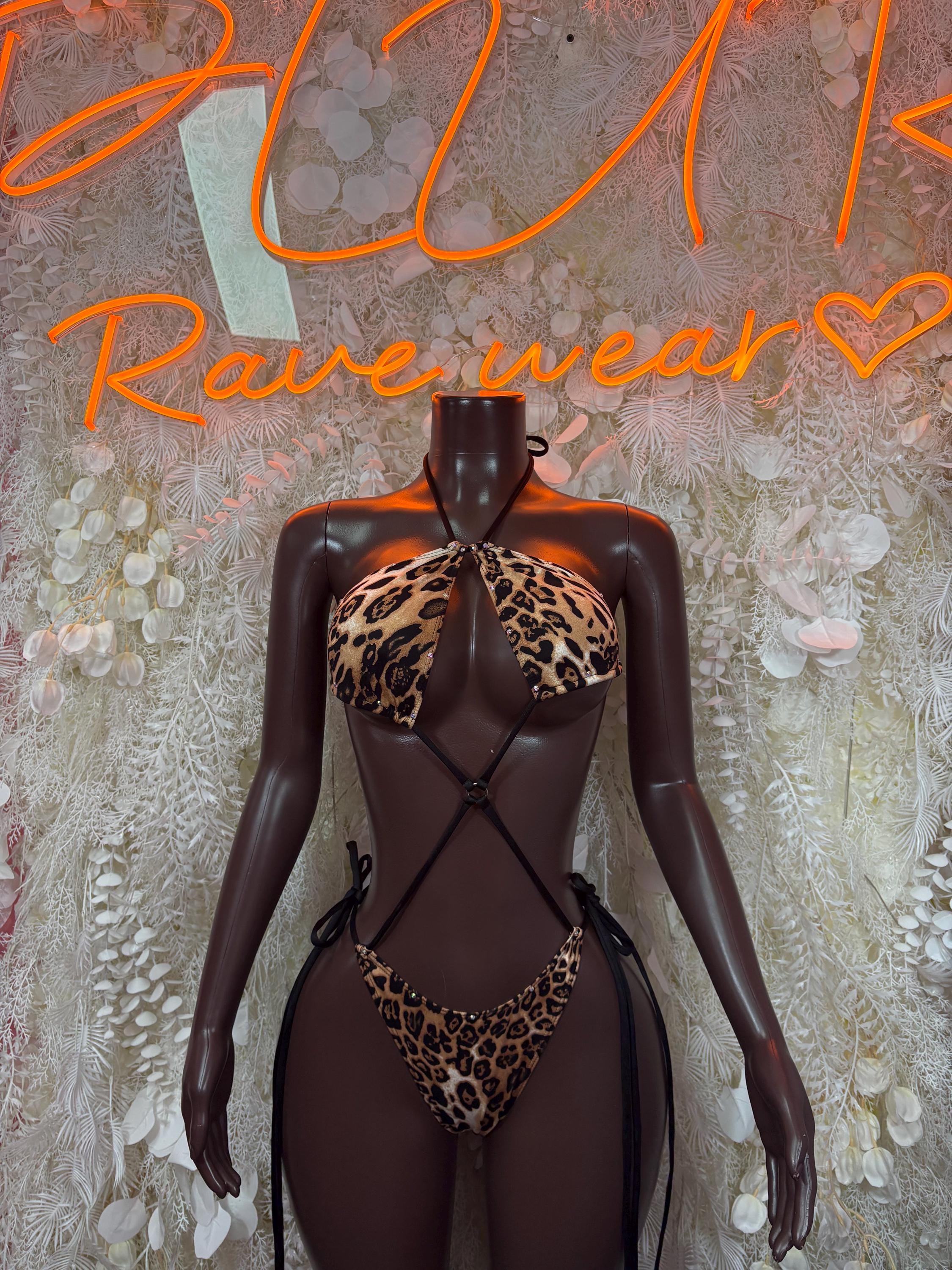 Leopard print one-piece bodysuit with deep V neck and crisscross straps, sheer mesh