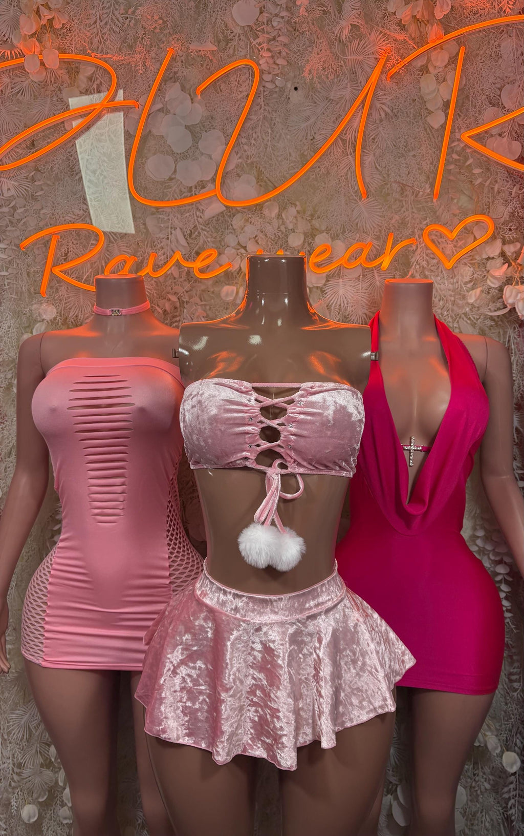 Pink mini bodysuit with choker and cutout front, shown with silver sequined top and red dress