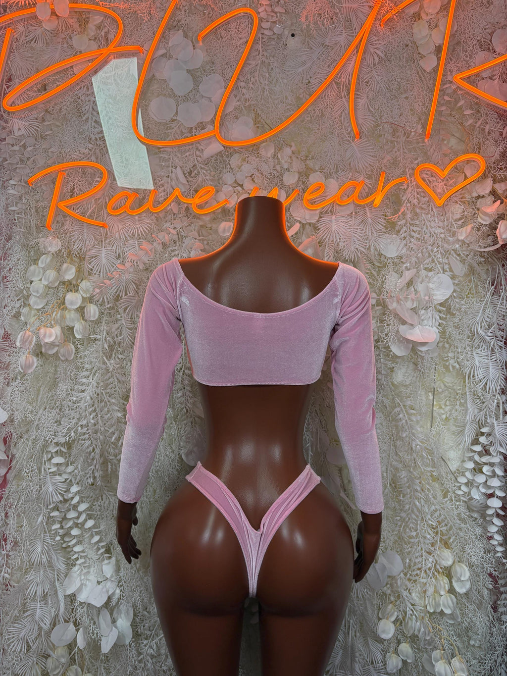 Pink velvet two-piece: long-sleeve crop top with wide neckline and matching high-cut bottoms