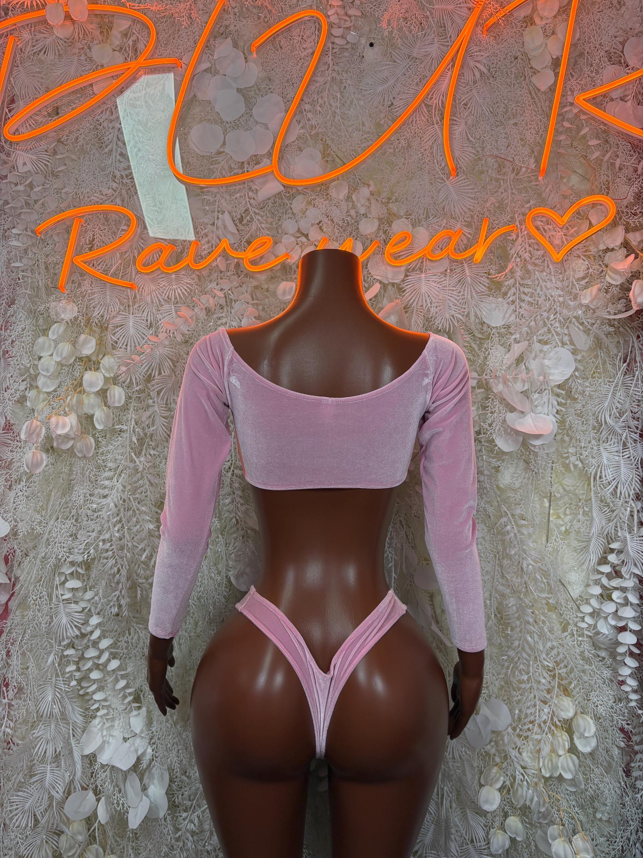 Pink velvet two-piece: long-sleeve crop top with wide neckline and matching high-cut bottoms