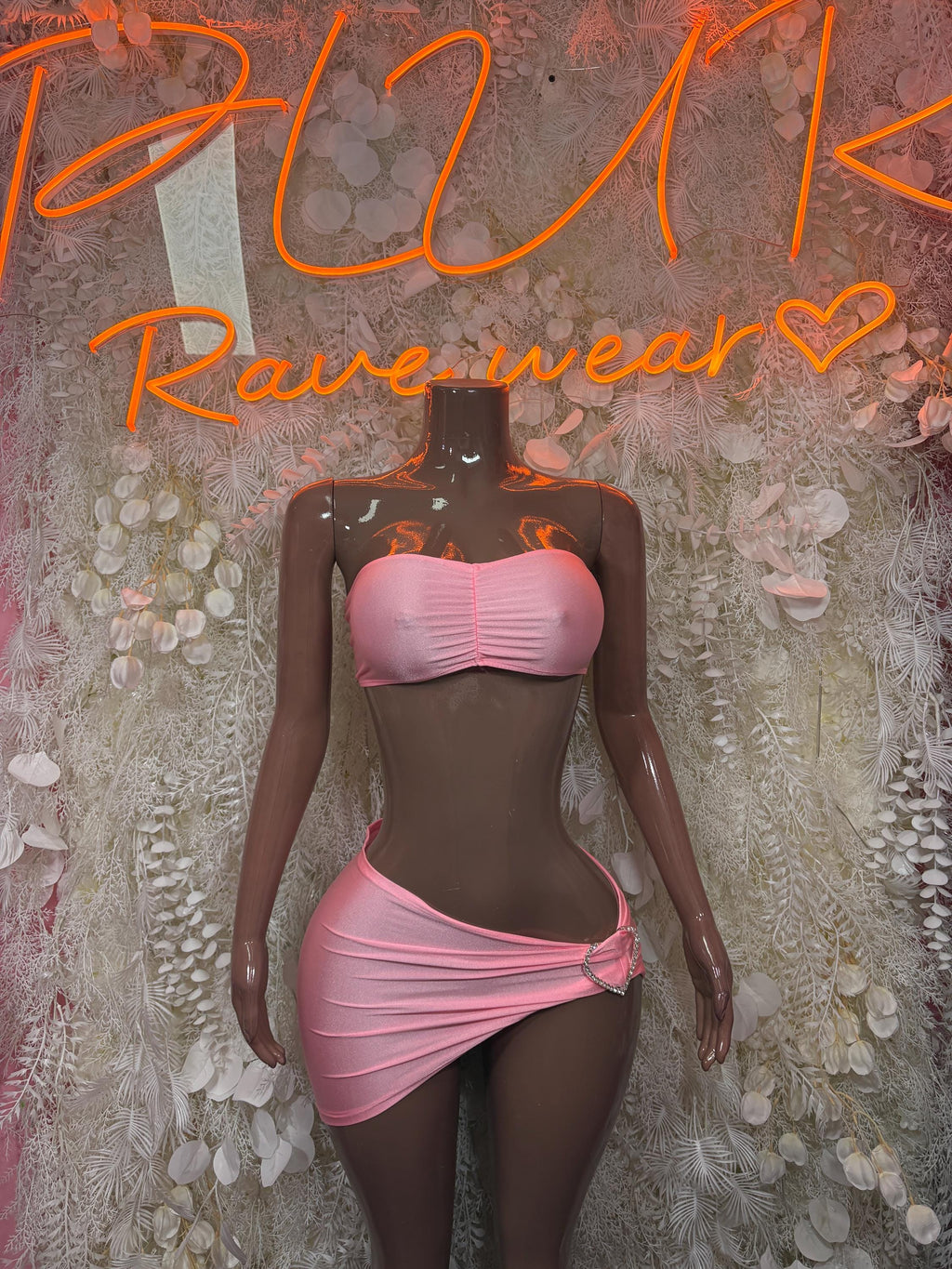 Pink two-piece skirt set with ruched bandeau top and tied mini skirt