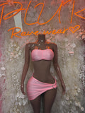 Pink two-piece skirt set with ruched bandeau top and tied mini skirt