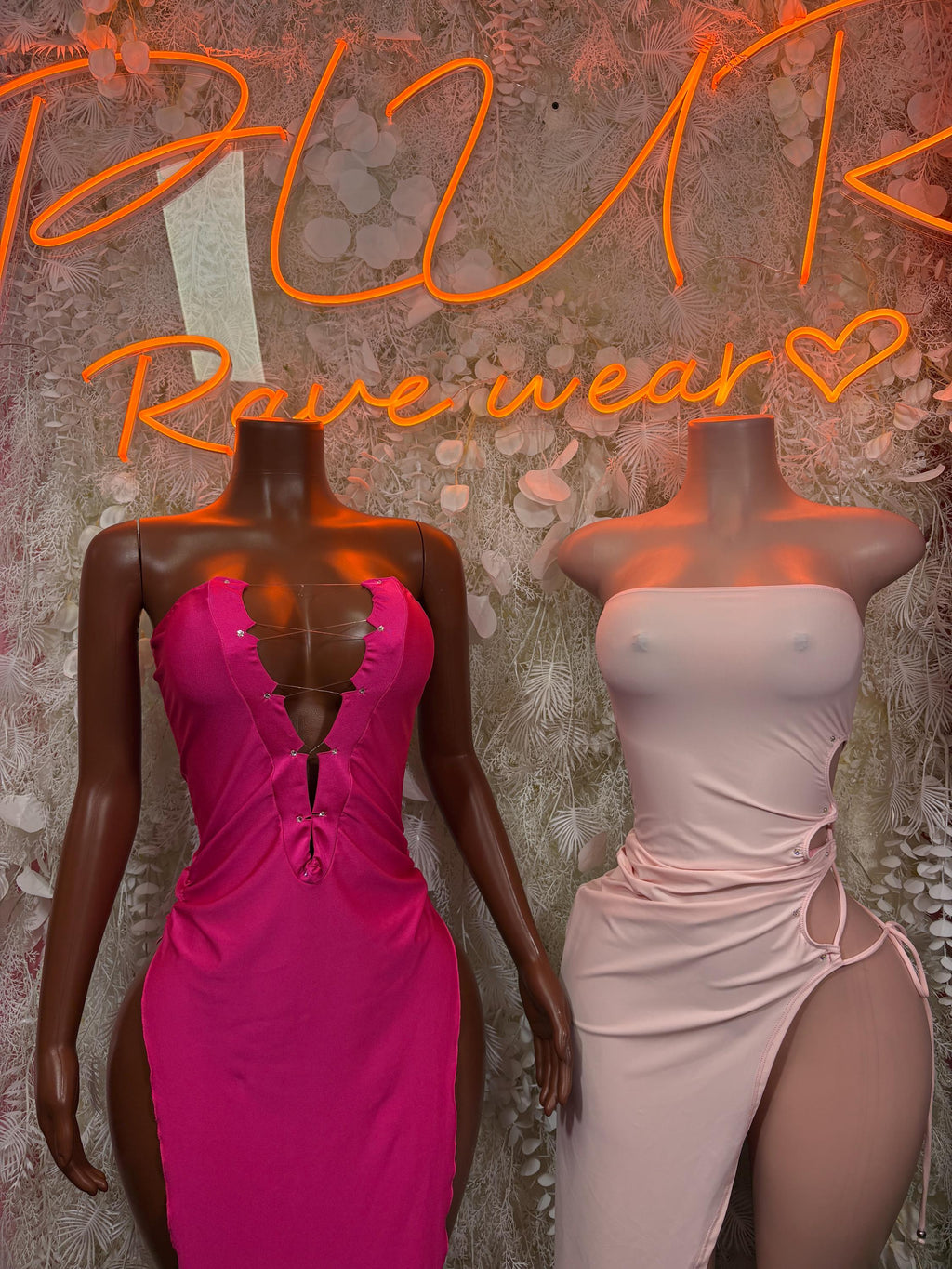 Two satin fitted club dresses: bright magenta V-neck and pale pink strapless