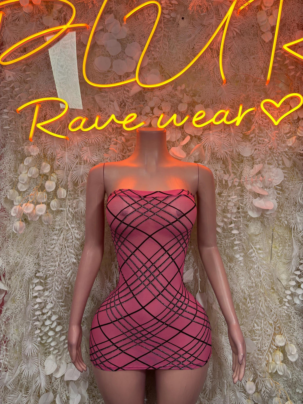 Pink strapless mini dress with black grid pattern, fitted bodycon silhouette