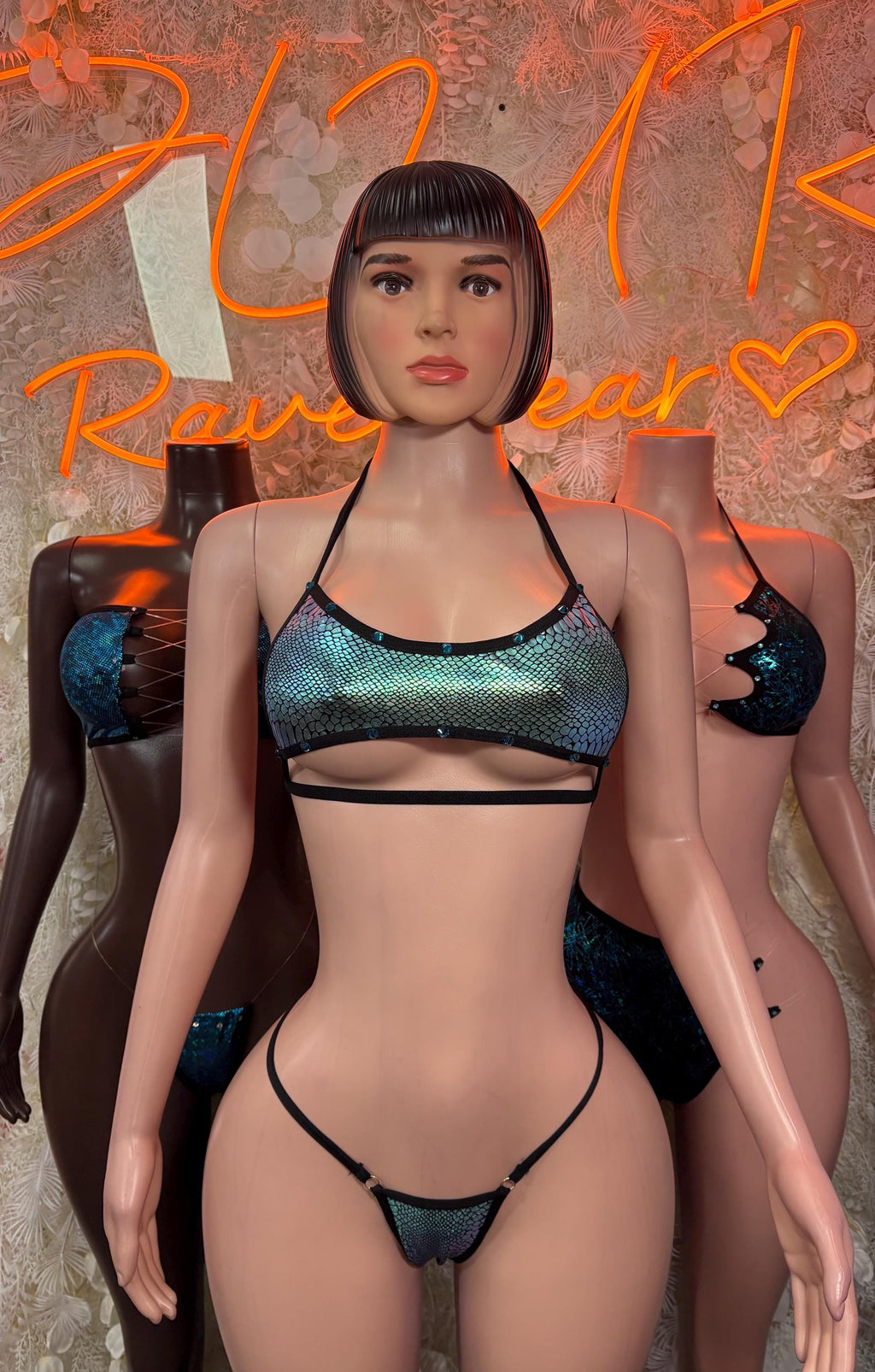 Iridescent blue-teal snakeskin bikini with black halter straps and Brazilian-style bottoms