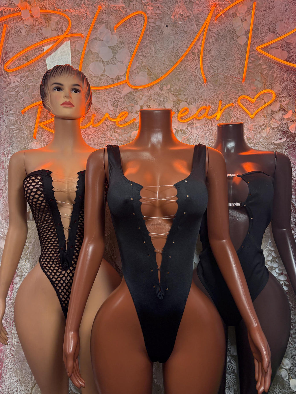Black lace-up bodysuit with sheer lace panels and deep V neckline