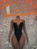 Black strapless-style bodysuit one-piece with button front and deep sweetheart neckline