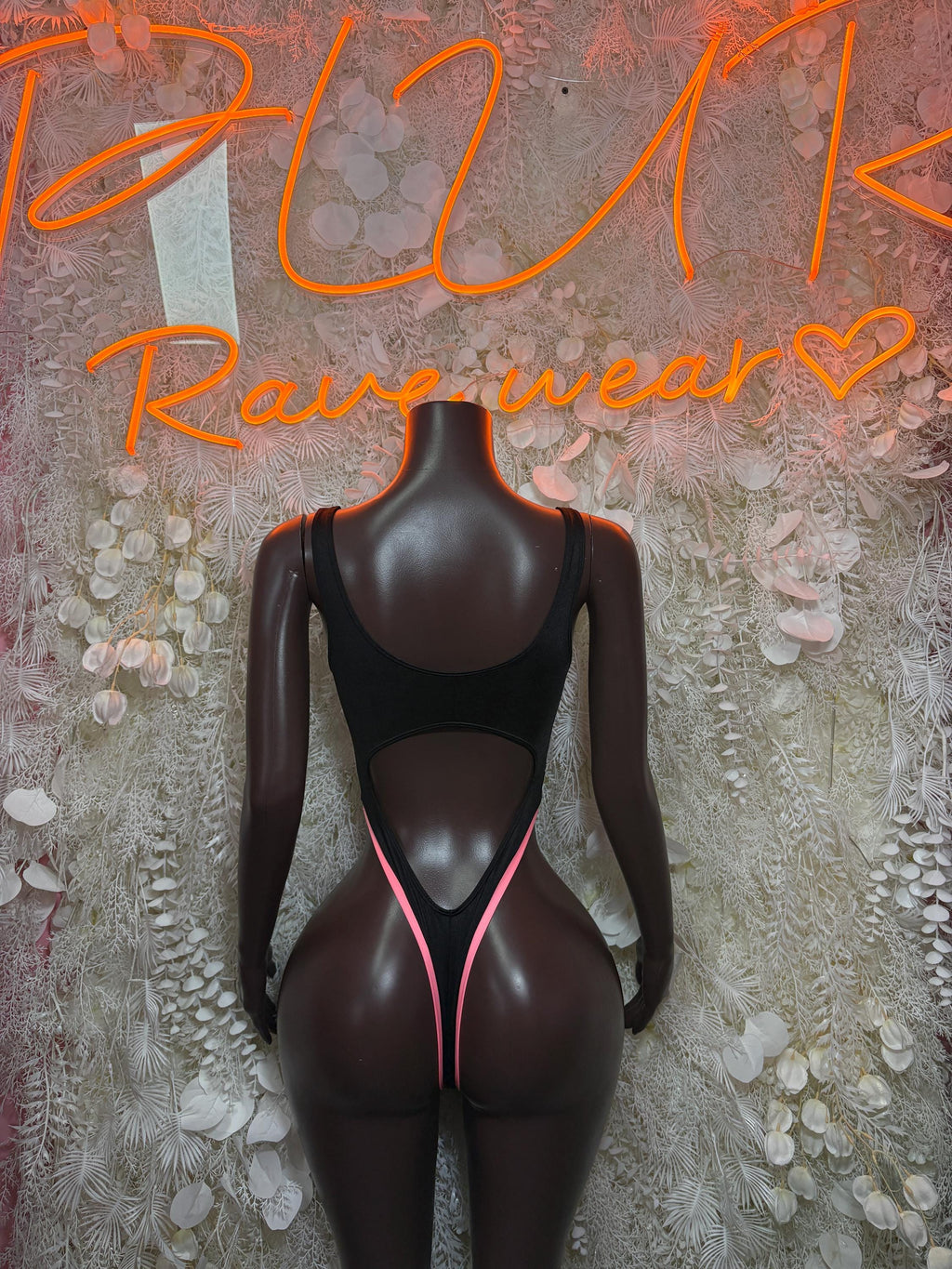 Black bodysuit with neon pink V-trim open back and cutout center