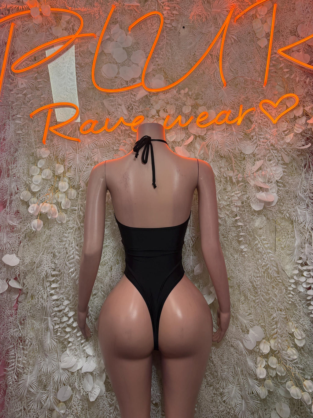 Black backless bodysuit with crisscross straps and open cutout sides