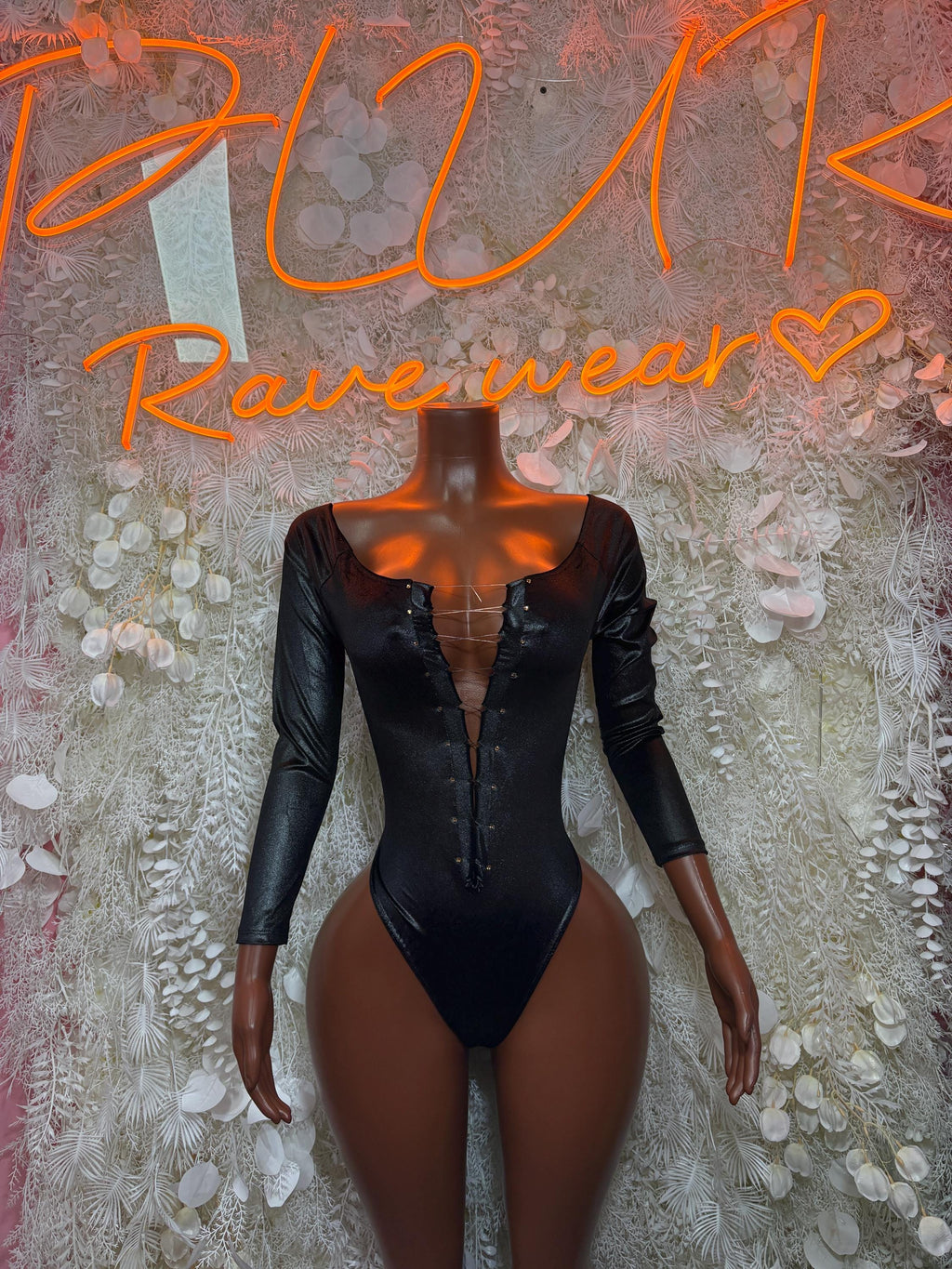 Black long-sleeve bodysuit with lace-up front and high-cut leg openings