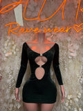 Dark green velvet mini dress with long sleeves, oval cutout neckline and waist