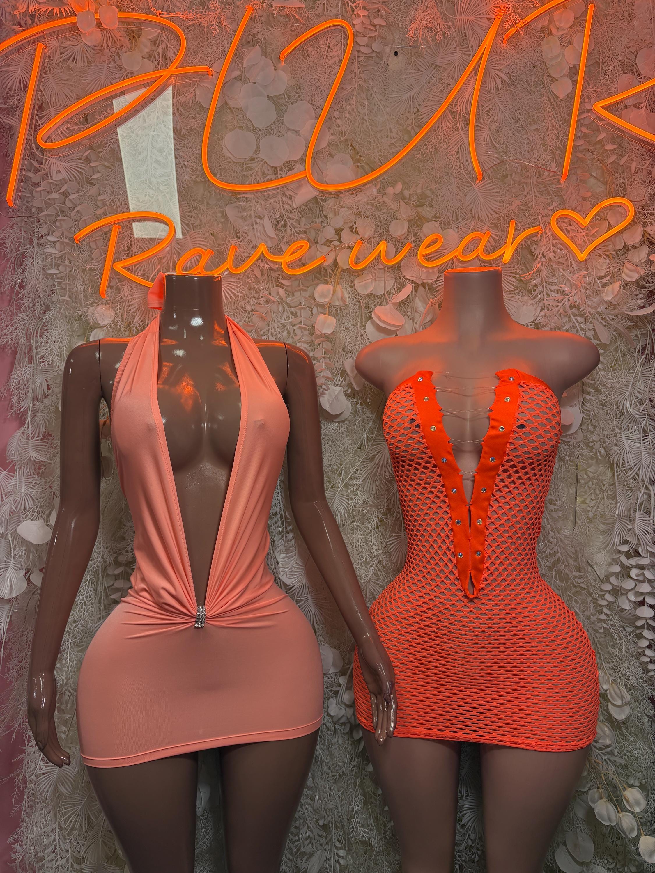 Orange fishnet one-piece dress beside orange halter mini dress