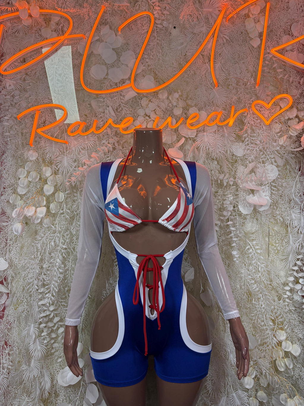 Rave bodysuit with star-and-stripe triangle print, blue shorts, long sheer sleeves