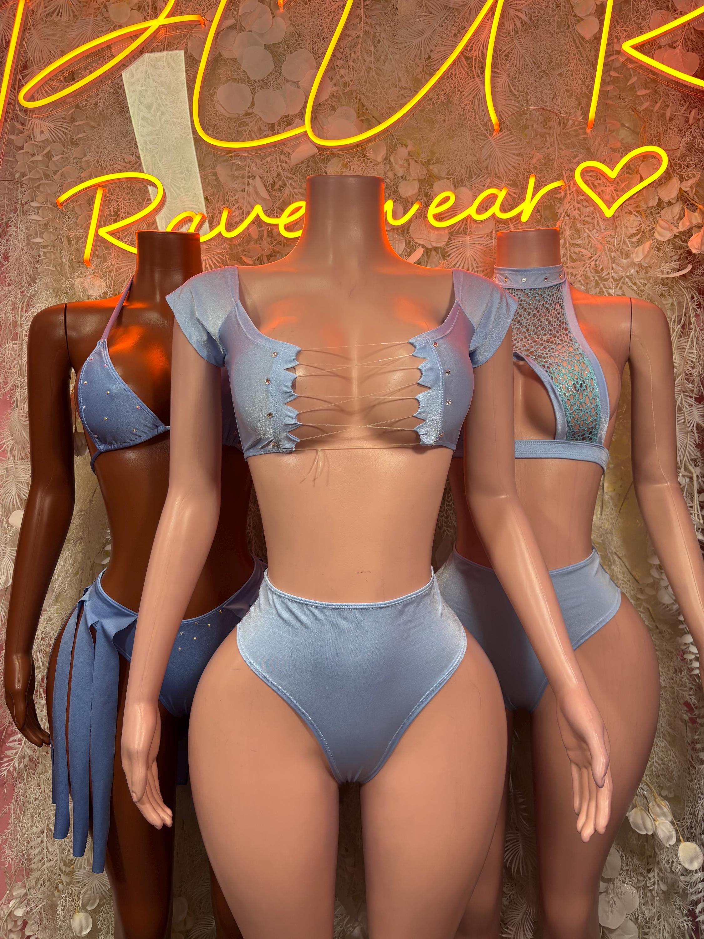 Light blue two-piece rave outfit with ruched crop top, short sleeves, and high-cut bottoms