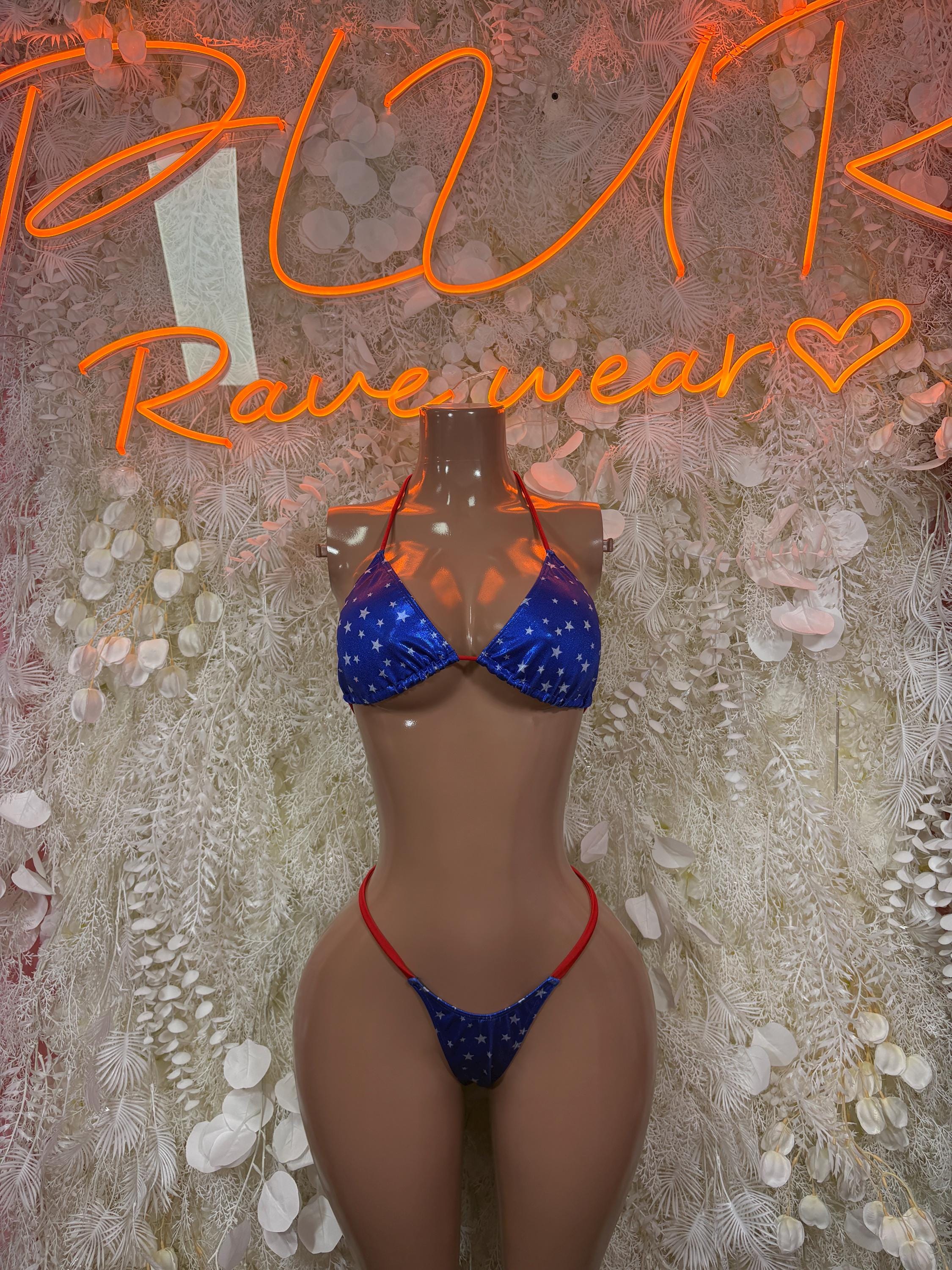 Two-piece bikini swimsuit with blue star print and red trim, triangle top and tie bottoms