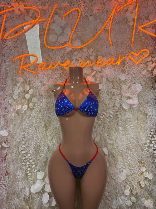 Two-piece bikini swimsuit with blue star print and red trim, triangle top and tie bottoms