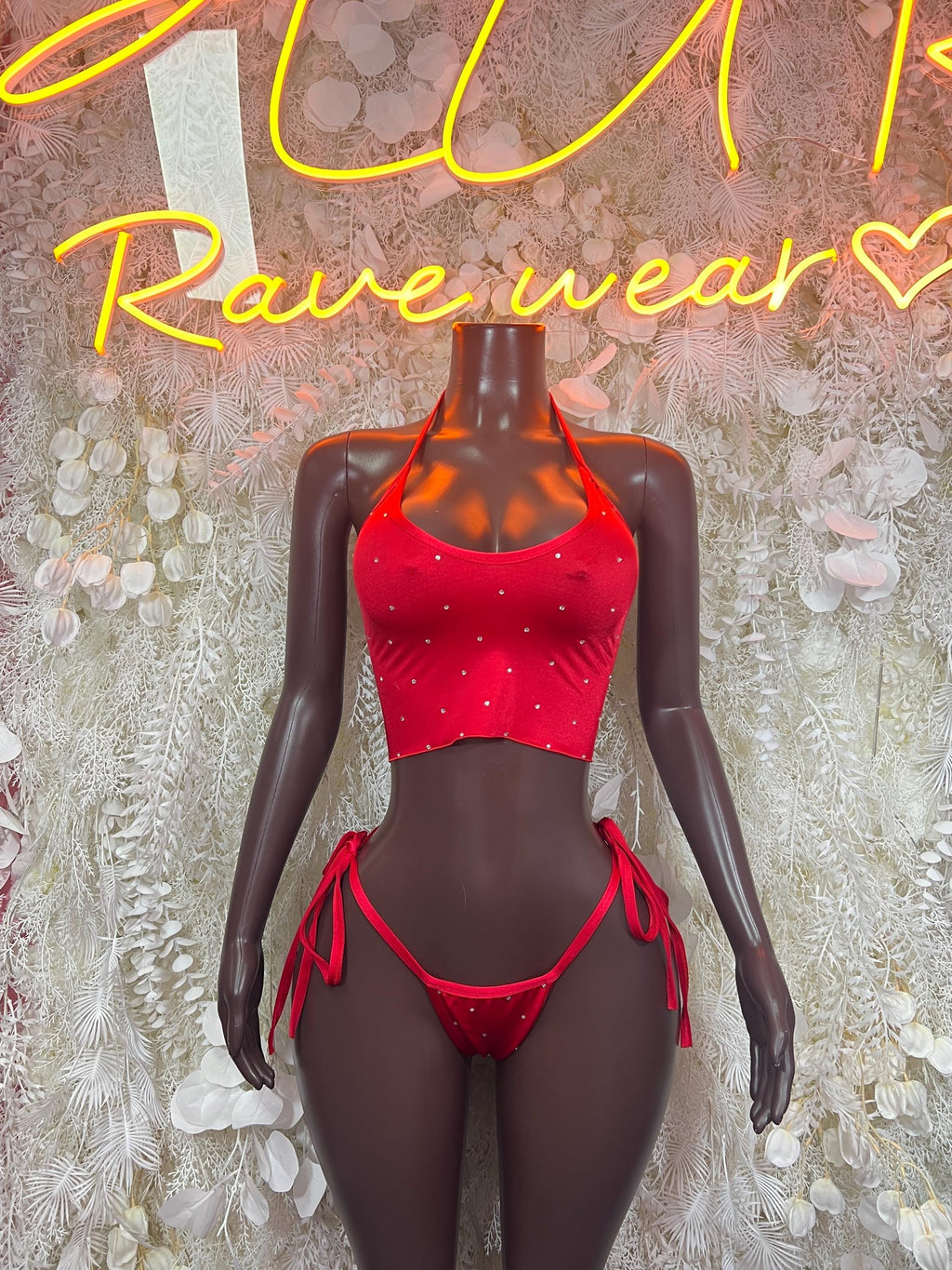 Red glitter crop top and tie-side bikini bottom set on mannequin, front view
