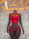 Red glitter crop top and tie-side bikini bottom set on mannequin, front view